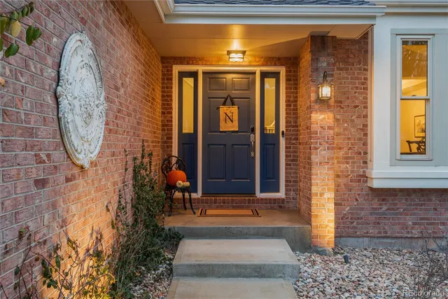 a view of entrance door of the house and front view of a house