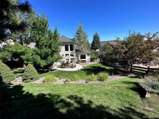 a view of a chair and table on the garden