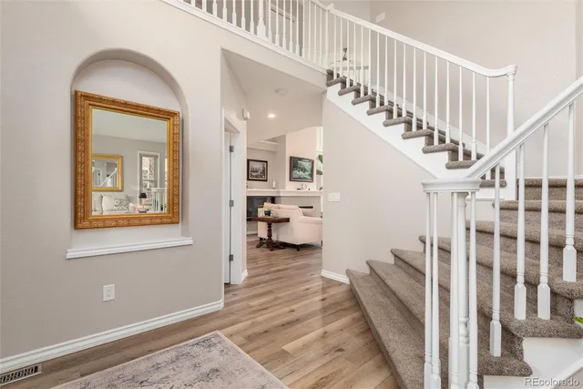 a view of entryway and hall with wooden floor