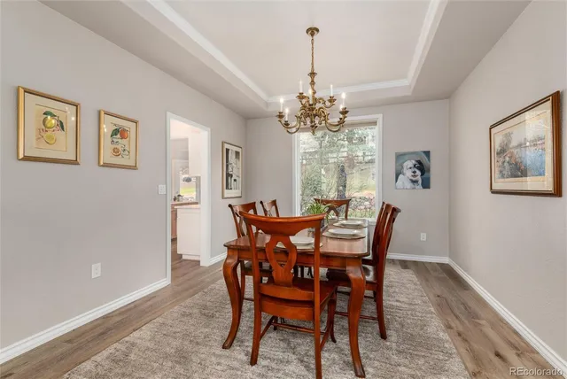 a view of a dining room with furniture and chandelier
