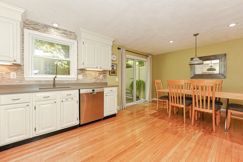 9 Apple Ridge Road, Unit 4 Maynard, MA 01754 - Photo 12 of 33 a kitchen with stainless steel appliances granite countertop wooden floors and white cabinets