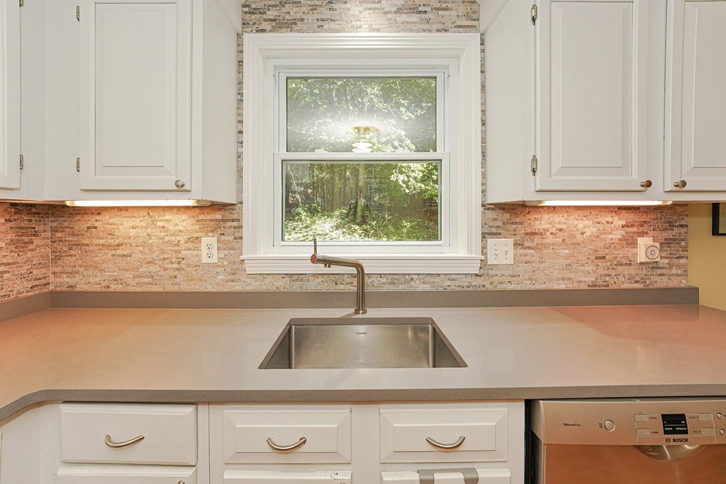 9 Apple Ridge Road, Unit 4 Maynard, MA 01754 - Photo 13 of 33 a kitchen with granite countertop white cabinets and a window