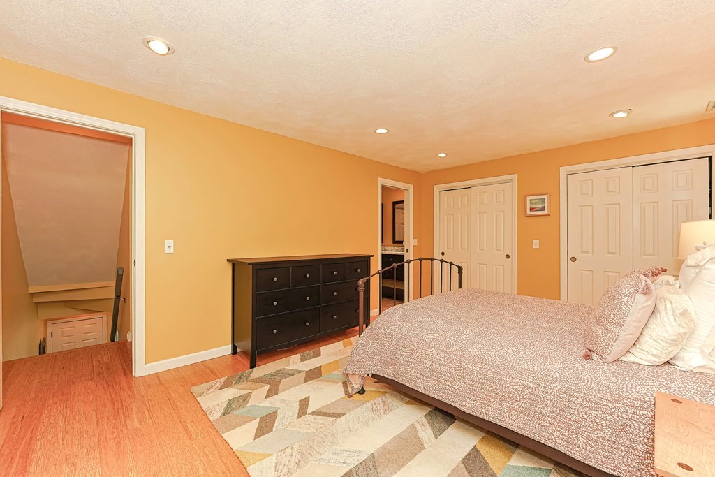 9 Apple Ridge Road, Unit 4 Maynard, MA 01754 - Photo 16 of 33 a bedroom with a bed and a dresser
