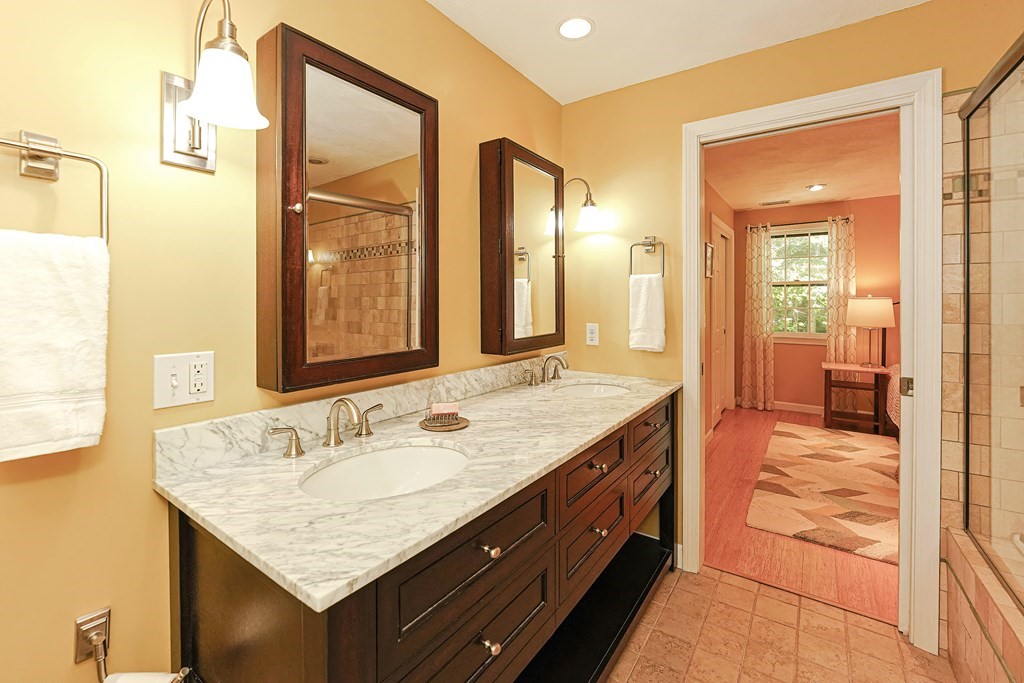 9 Apple Ridge Road, Unit 4 Maynard, MA 01754 - Photo 18 of 33 a bathroom with a granite countertop sink and a mirror