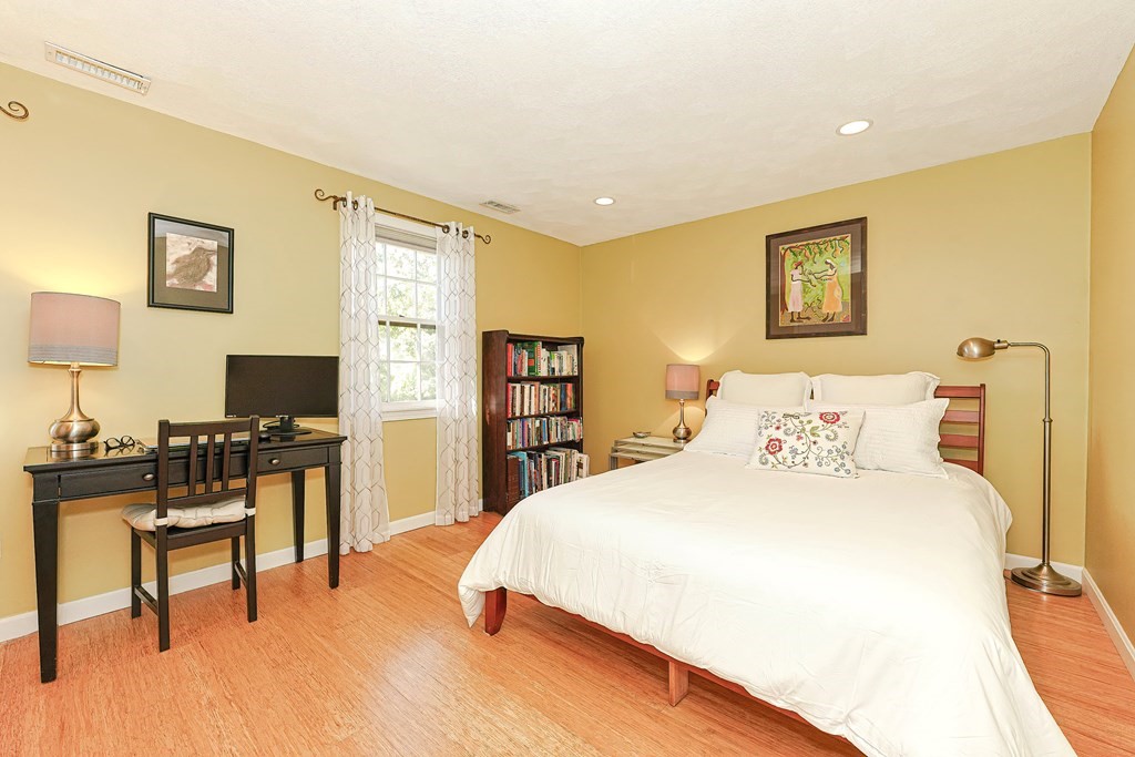 9 Apple Ridge Road, Unit 4 Maynard, MA 01754 - Photo 20 of 33 a bedroom with a bed and a desk