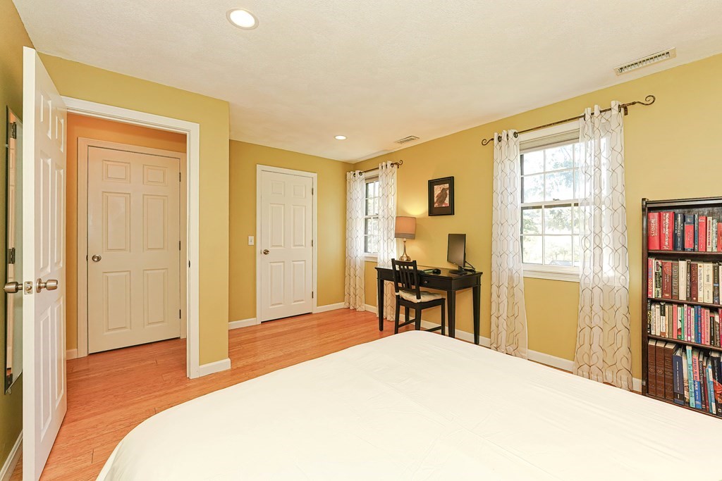 9 Apple Ridge Road, Unit 4 Maynard, MA 01754 - Photo 21 of 33 a bedroom with a bed and a book shelf