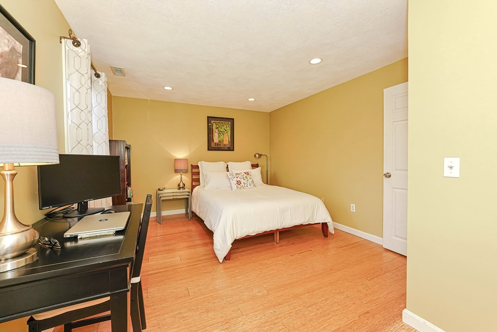 9 Apple Ridge Road, Unit 4 Maynard, MA 01754 - Photo 22 of 33 a bedroom with a bed and a computer on a table