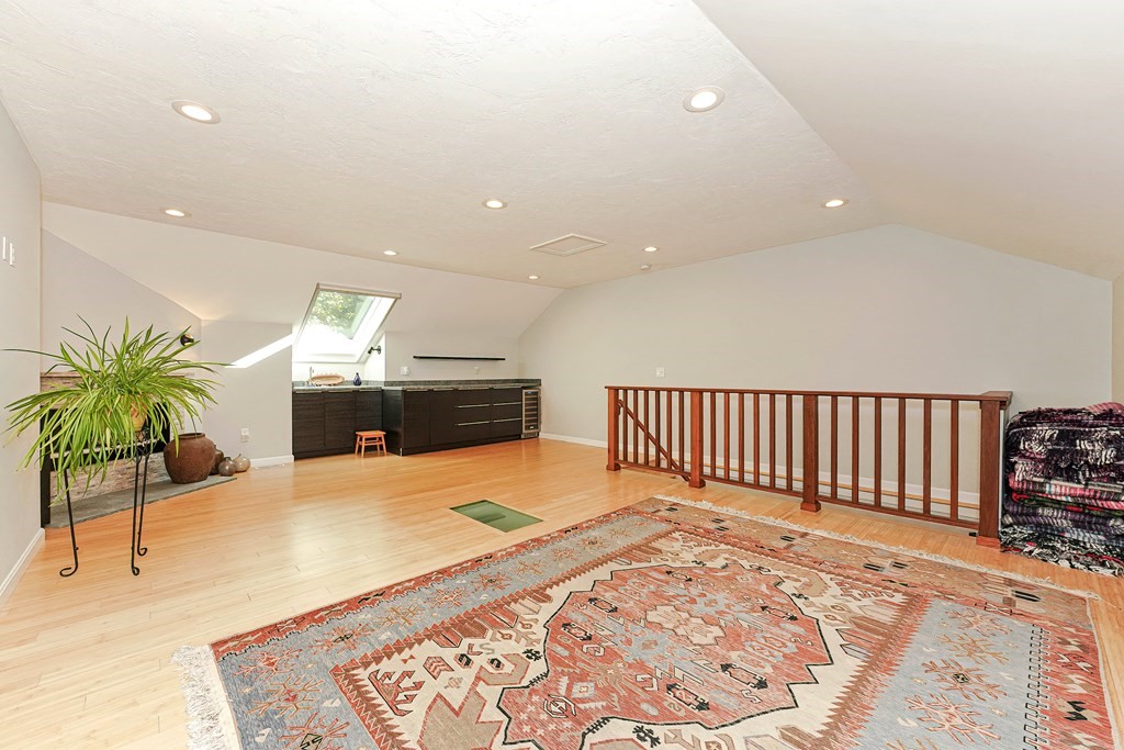 9 Apple Ridge Road, Unit 4 Maynard, MA 01754 - Photo 24 of 33 a bedroom with a bed and a chandelier