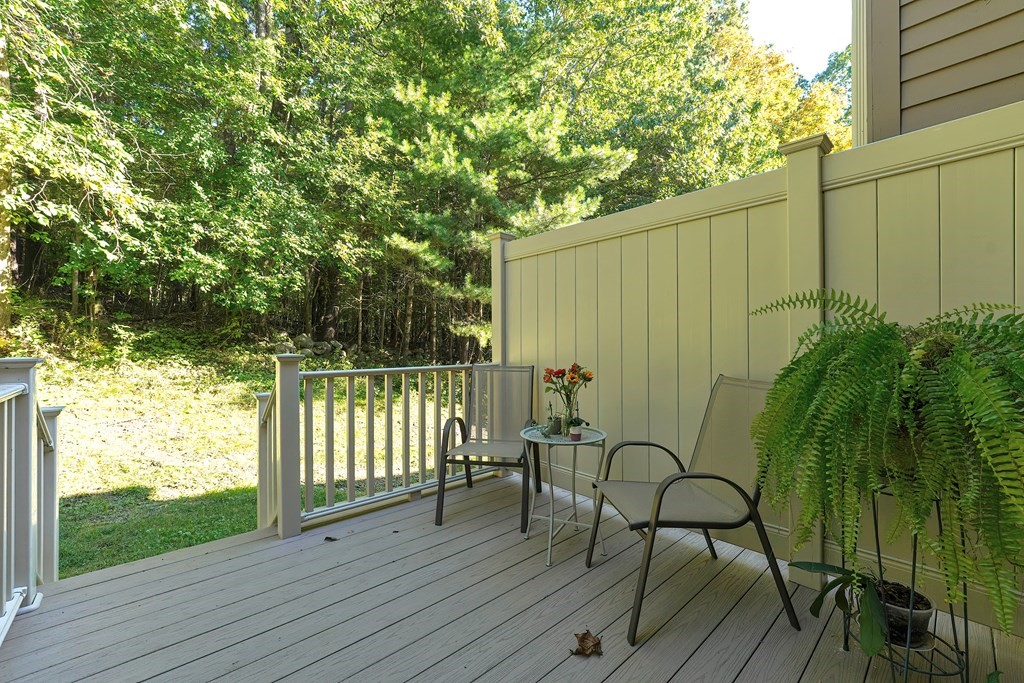 9 Apple Ridge Road, Unit 4 Maynard, MA 01754 - Photo 28 of 33 a view of a balcony with chairs and wooden fence