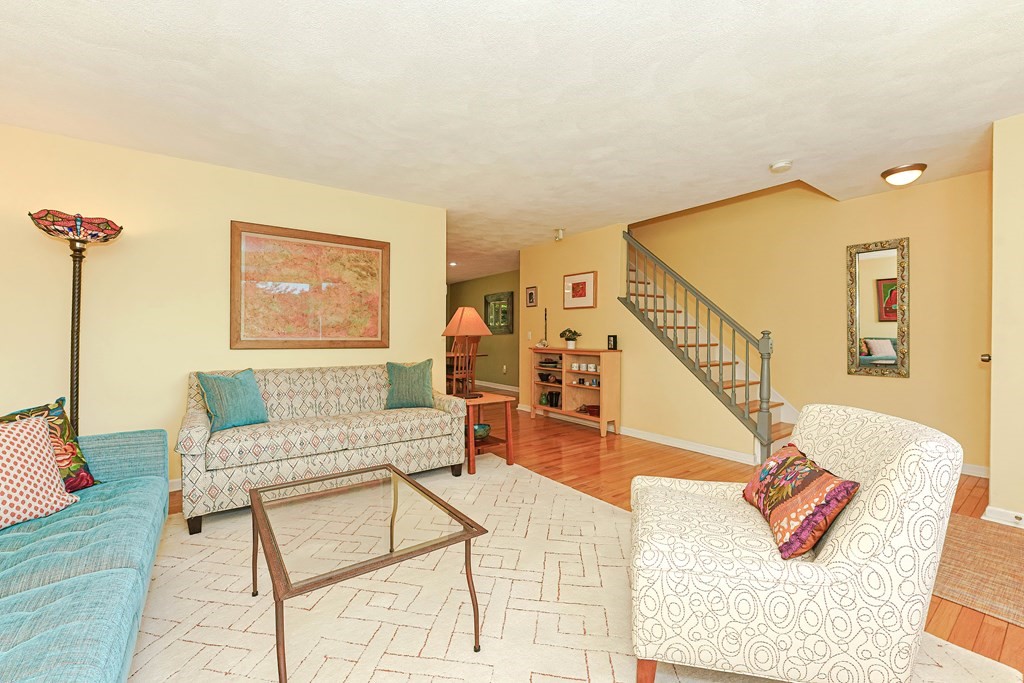 9 Apple Ridge Road, Unit 4 Maynard, MA 01754 - Photo 6 of 33 a living room with furniture and a wooden floor