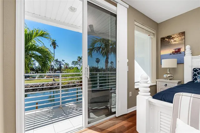 a spacious bedroom with a bed and wooden floor