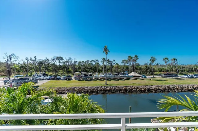 an aerial view of waterside residential houses with outdoor space and parking