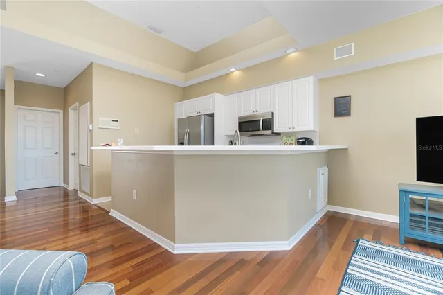 a kitchen with white cabinets and white appliances