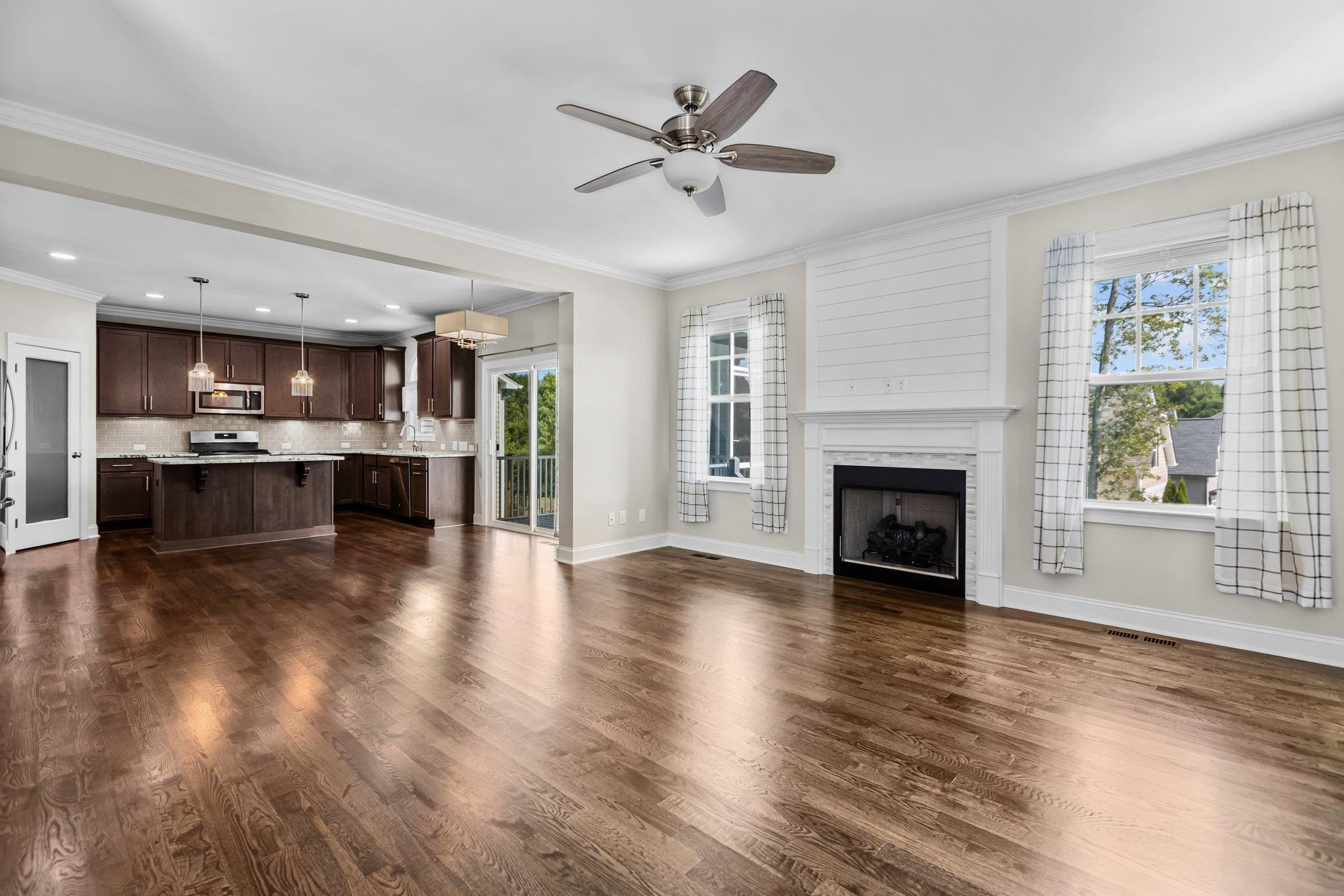 357 Marshcroft Way Rolesville, NC 27571 - Photo 11 of 52 an empty room with kitchen fireplace and windows