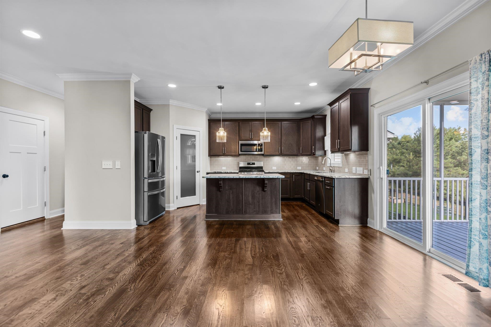 357 Marshcroft Way Rolesville, NC 27571 - Photo 12 of 52 a kitchen with stainless steel appliances granite countertop a refrigerator oven a sink dishwasher and a stove with wooden floor