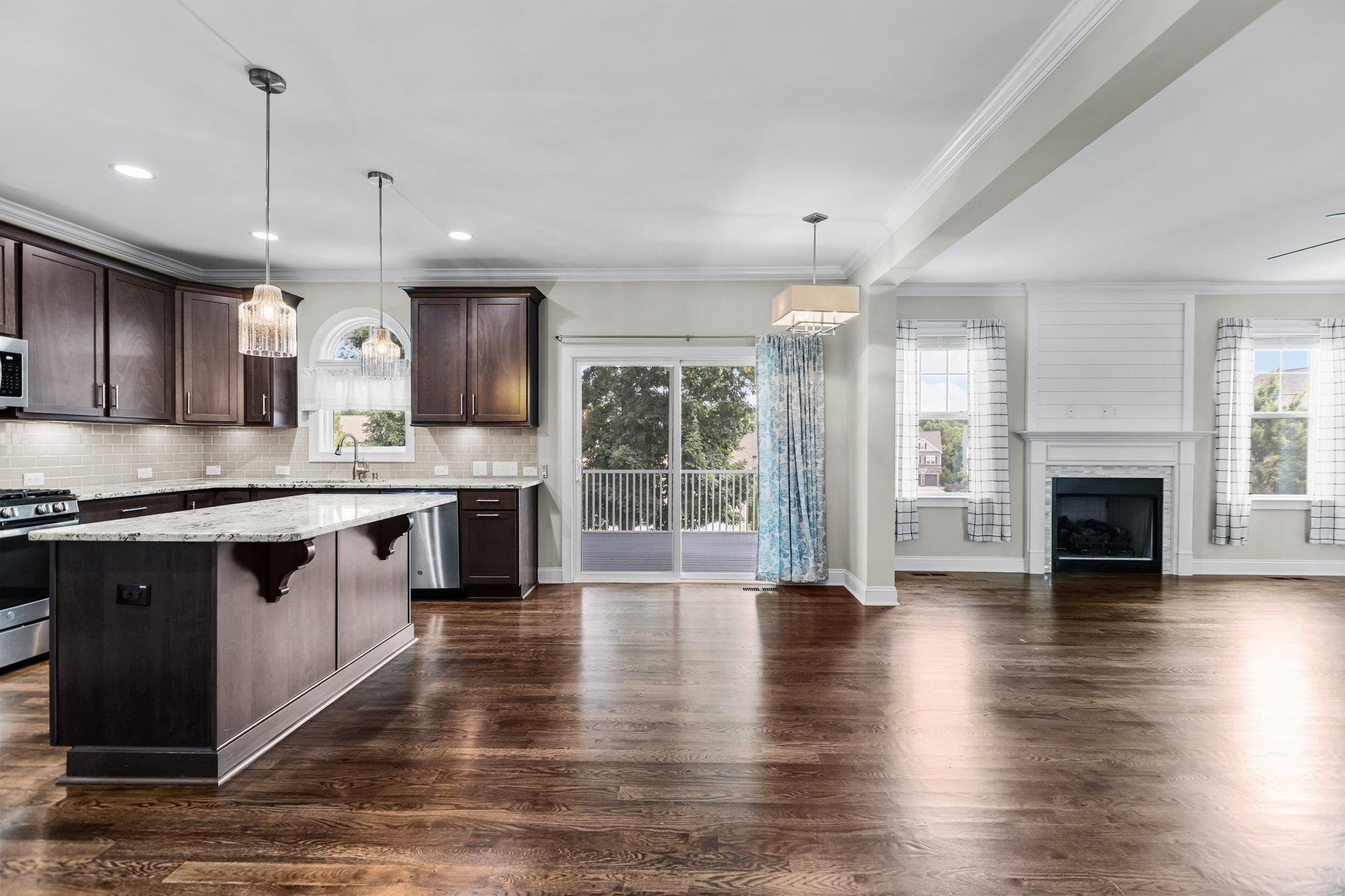 357 Marshcroft Way Rolesville, NC 27571 - Photo 13 of 52 a large kitchen with stainless steel appliances granite countertop a stove and a wooden floors