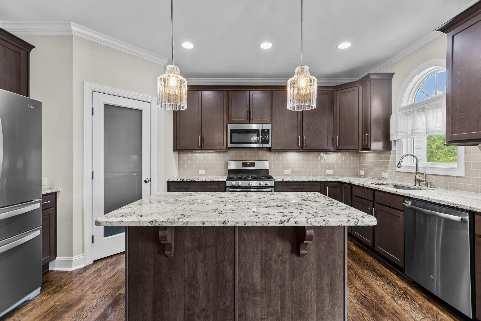 357 Marshcroft Way Rolesville, NC 27571 - Photo 18 of 52 a kitchen with kitchen island granite countertop a sink stove and refrigerator