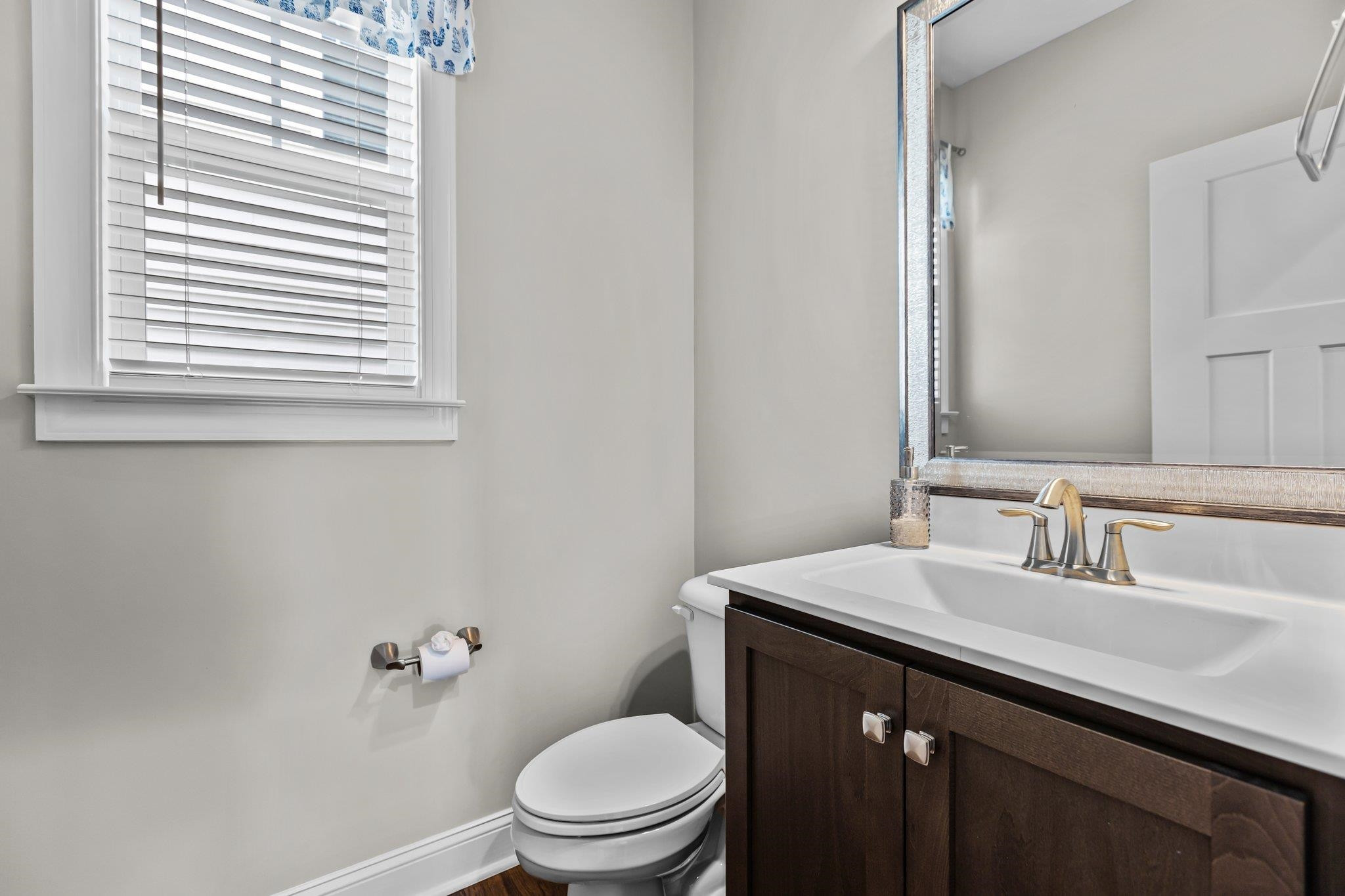 357 Marshcroft Way Rolesville, NC 27571 - Photo 21 of 52 a bathroom with a sink a toilet a mirror and a window