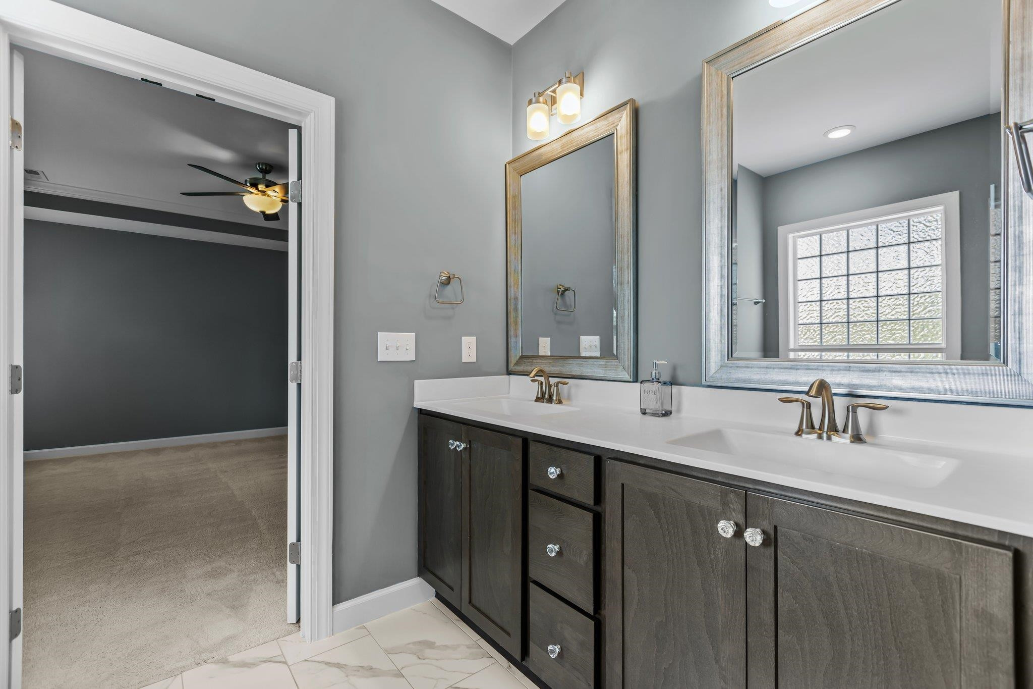 357 Marshcroft Way Rolesville, NC 27571 - Photo 29 of 52 a bathroom with a double vanity sink and mirror