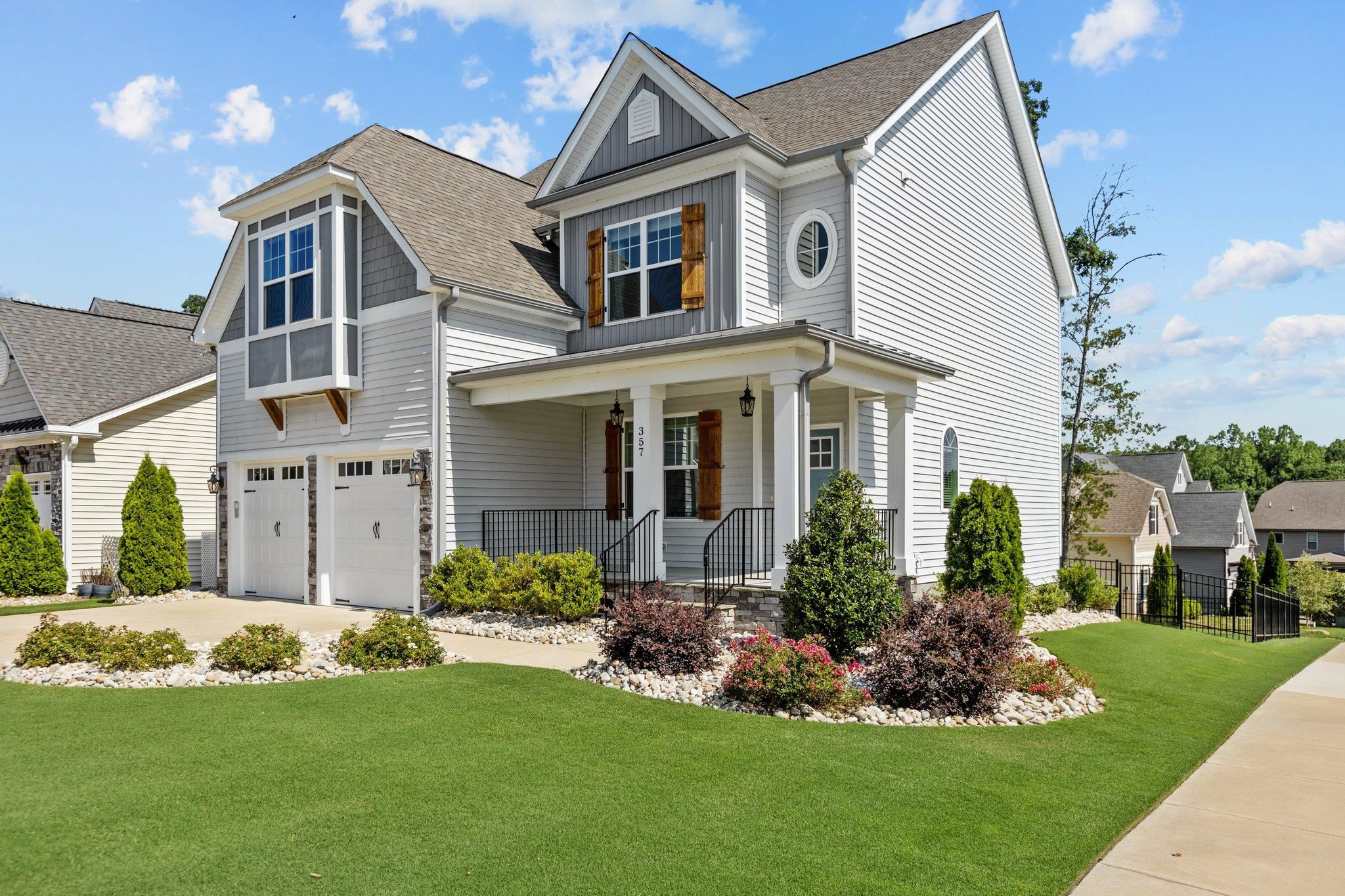 357 Marshcroft Way Rolesville, NC 27571 - Photo 3 of 52 a front view of a house with a yard and porch