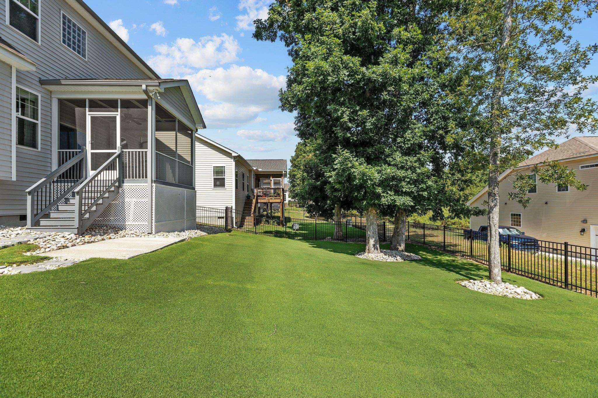 357 Marshcroft Way Rolesville, NC 27571 - Photo 44 of 52 a view of a backyard with table and chairs and large tree