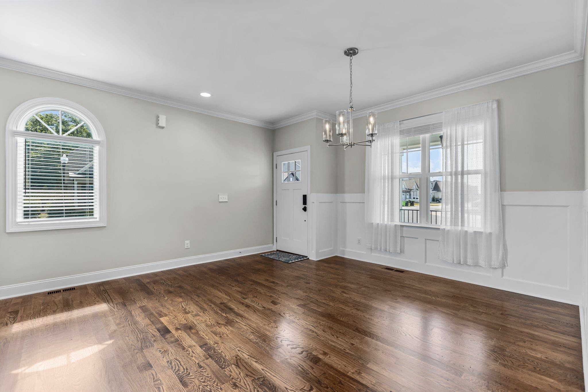 357 Marshcroft Way Rolesville, NC 27571 - Photo 5 of 52 a view of an empty room with a window and wooden floor