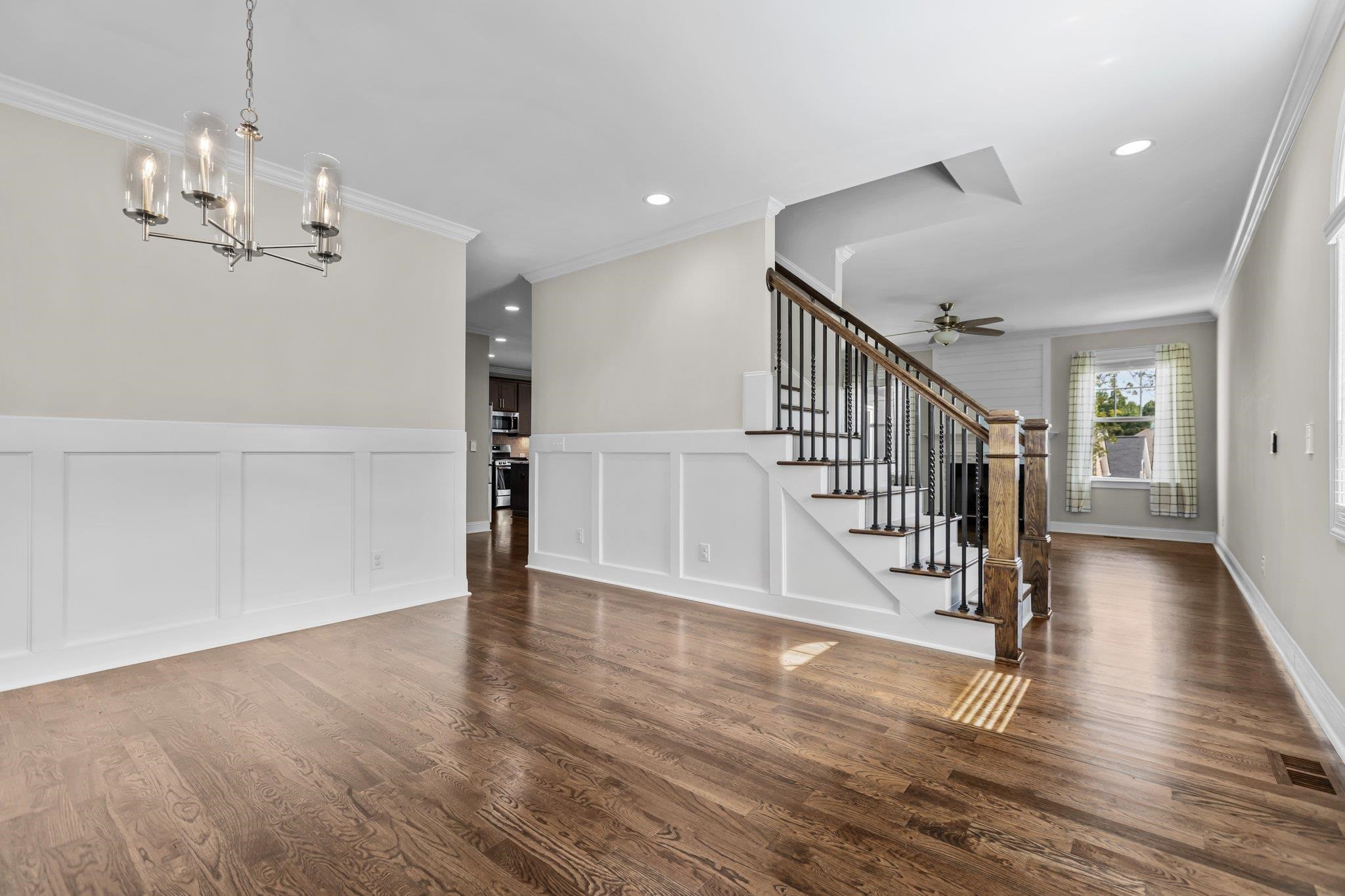 357 Marshcroft Way Rolesville, NC 27571 - Photo 7 of 52 a view of a room with wooden floor staircase and kitchen view