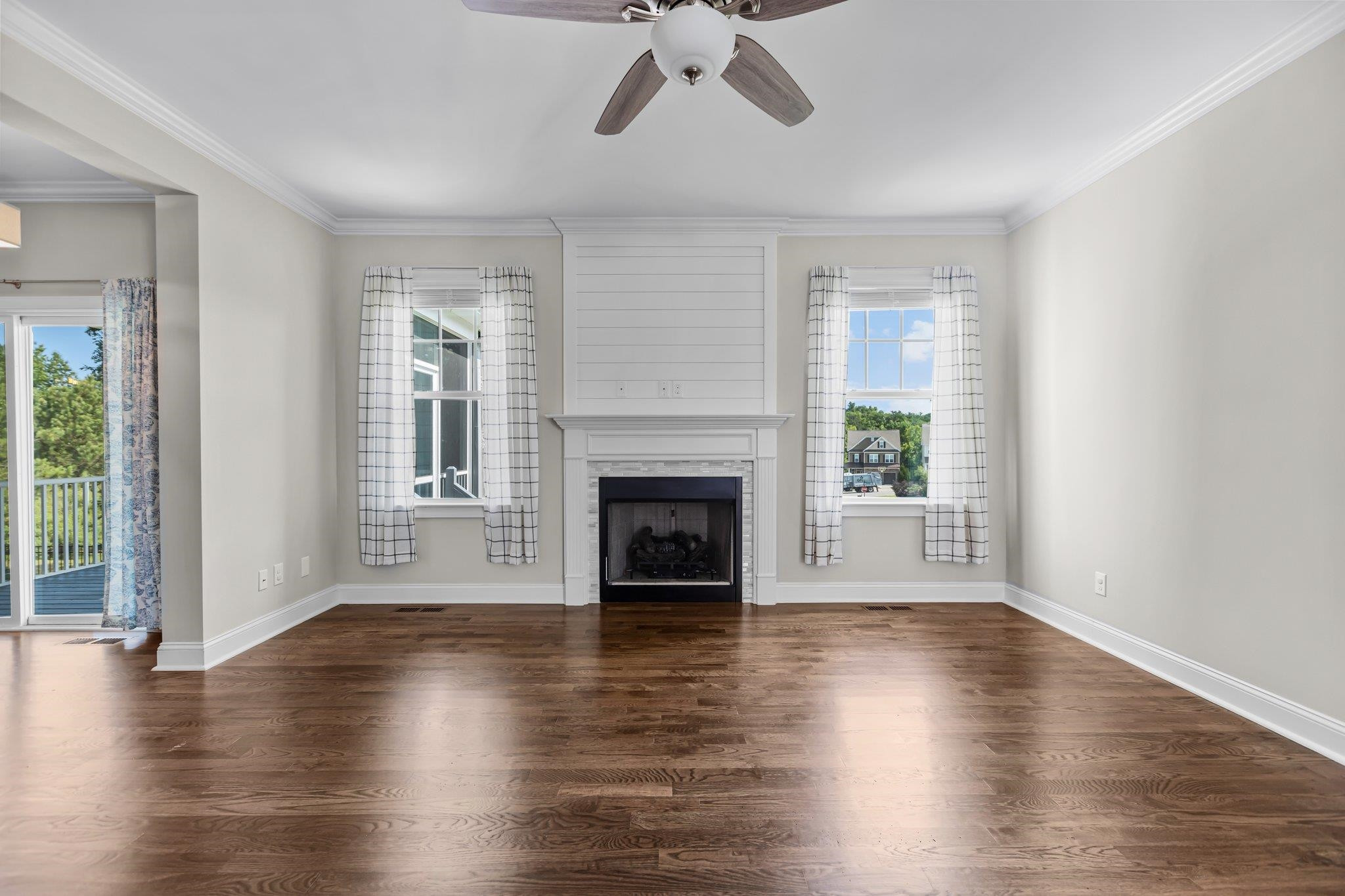 357 Marshcroft Way Rolesville, NC 27571 - Photo 10 of 52 a view of a livingroom with a fireplace wooden floor and a window