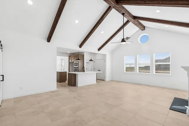 a kitchen with stainless steel appliances kitchen island a refrigerator and a stove top oven