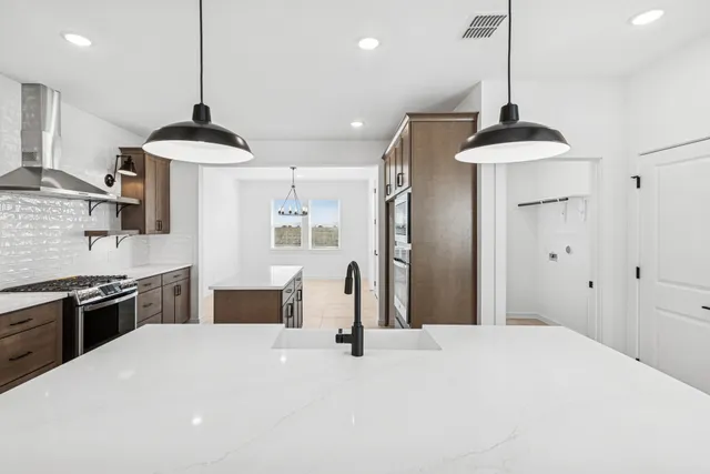 an empty room with windows and ceiling fan