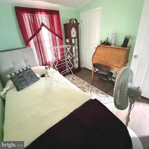 a bedroom with a bed and mirror