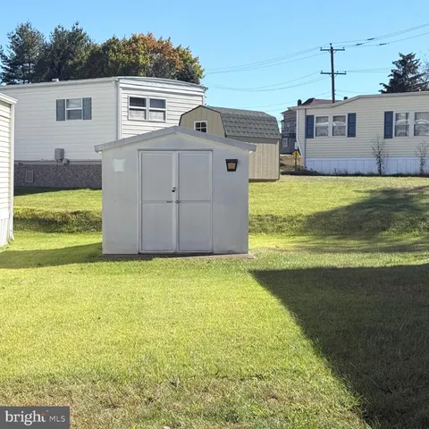 a front view of house with yard and garage