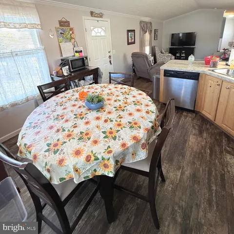 a bed sitting in a bedroom and a flat tv screen tv on wooden floor