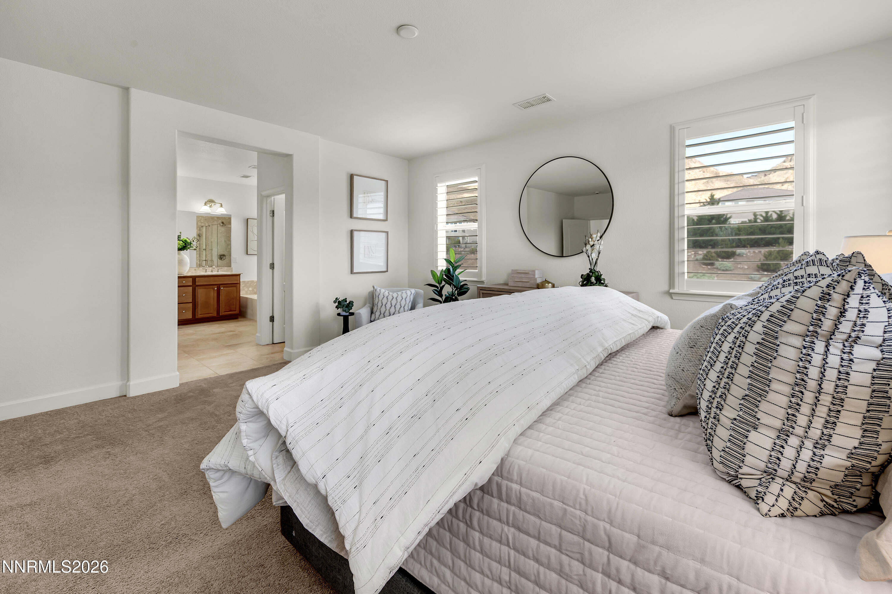 10150 Barrel Racer Drive Reno, NV 89521 - Photo 52 of 64 a bedroom with a bed mirror and window