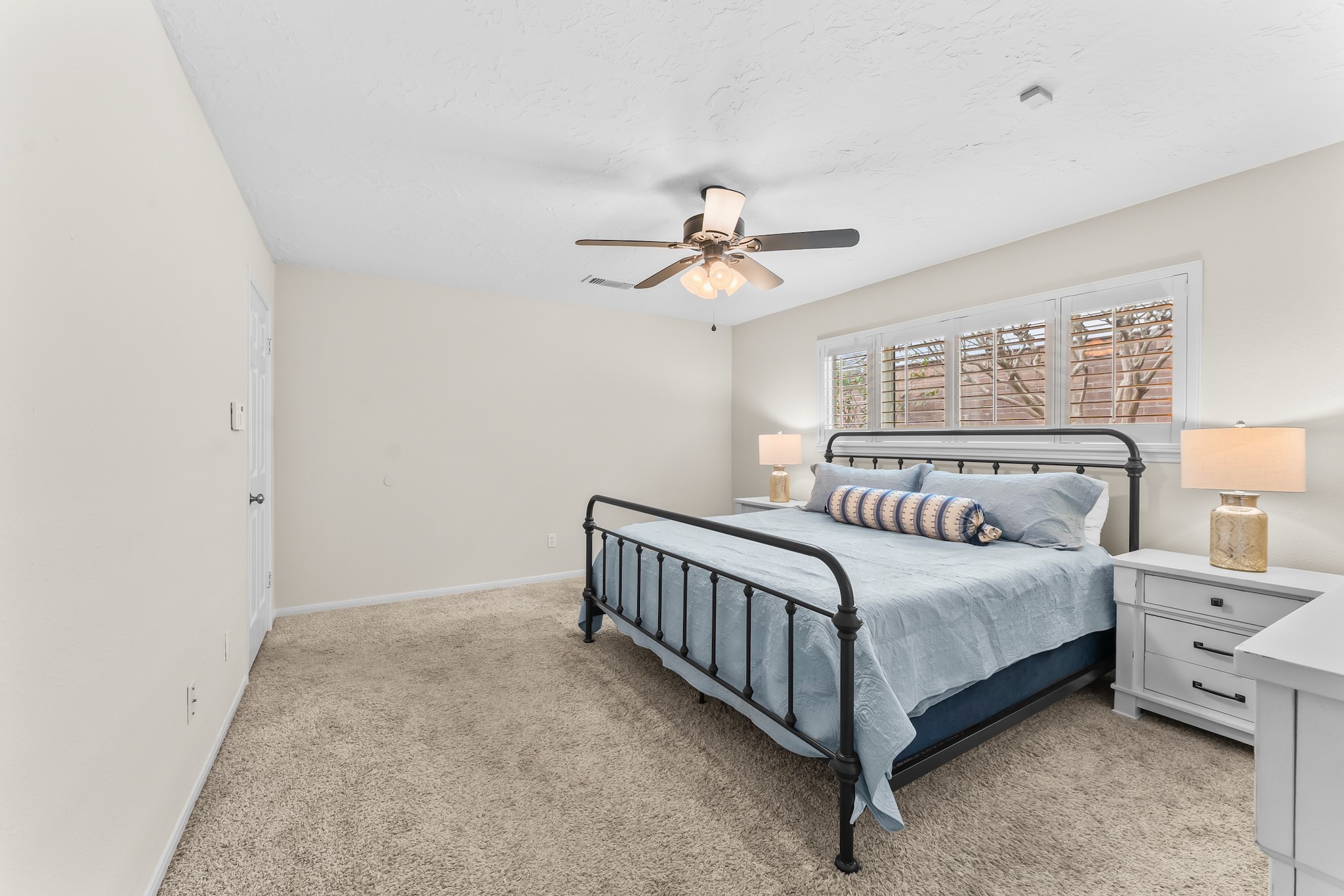1546 Beaconshire Houston, TX 77077 - Photo 17 of 29 a bedroom with a bed and a ceiling fan