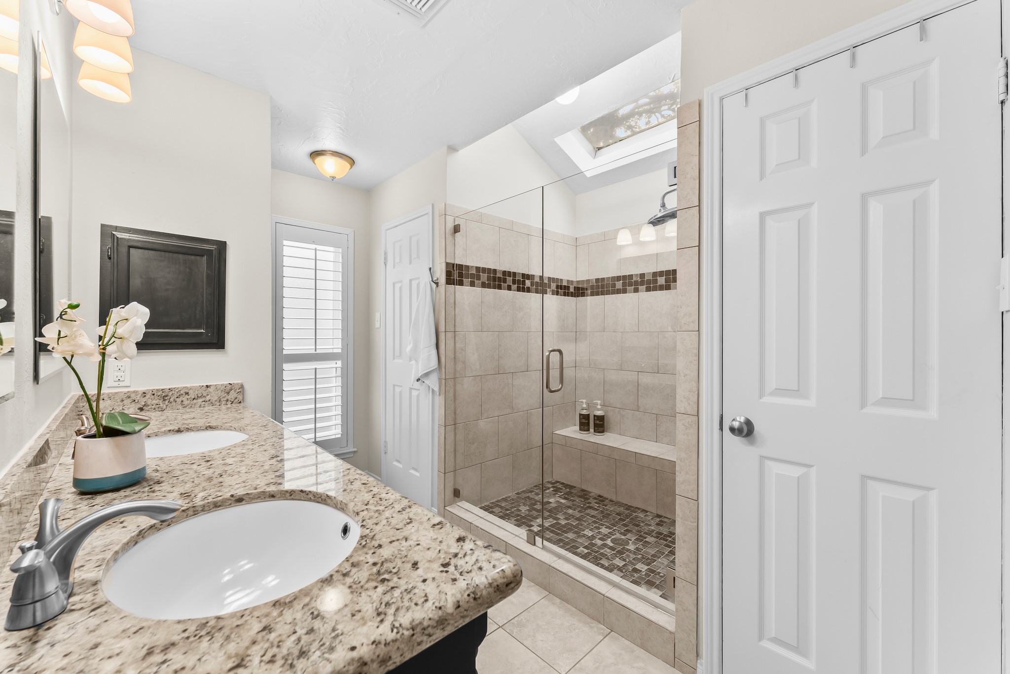 1546 Beaconshire Houston, TX 77077 - Photo 18 of 29 a bathroom with a granite countertop sink a mirror a vanity and shower