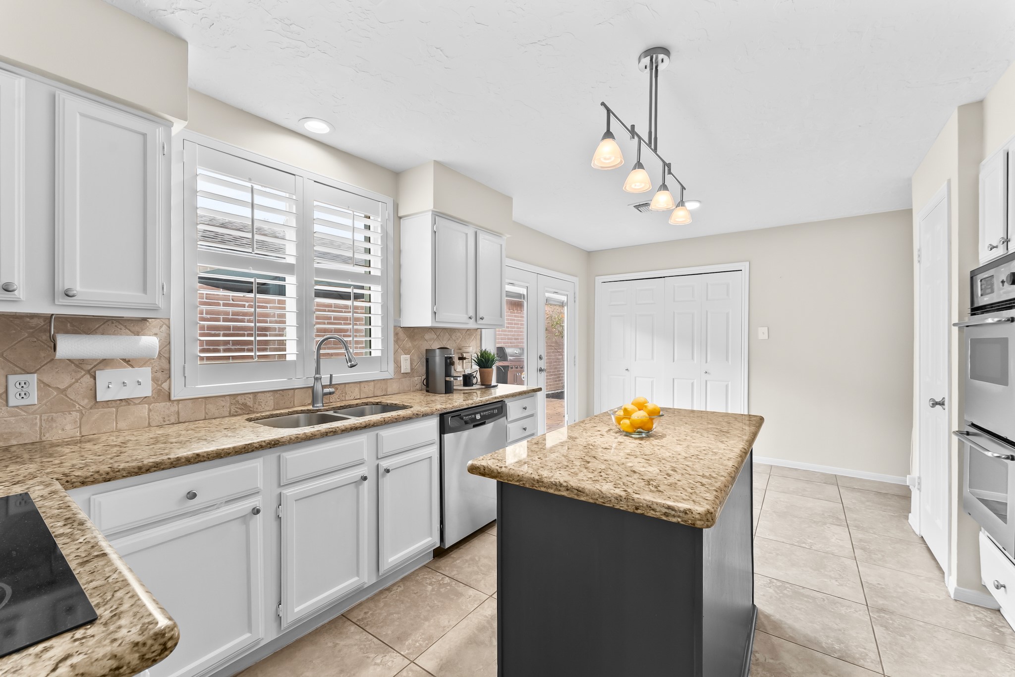 1546 Beaconshire Houston, TX 77077 - Photo 9 of 29 a kitchen with stainless steel appliances granite countertop a sink stove and cabinets