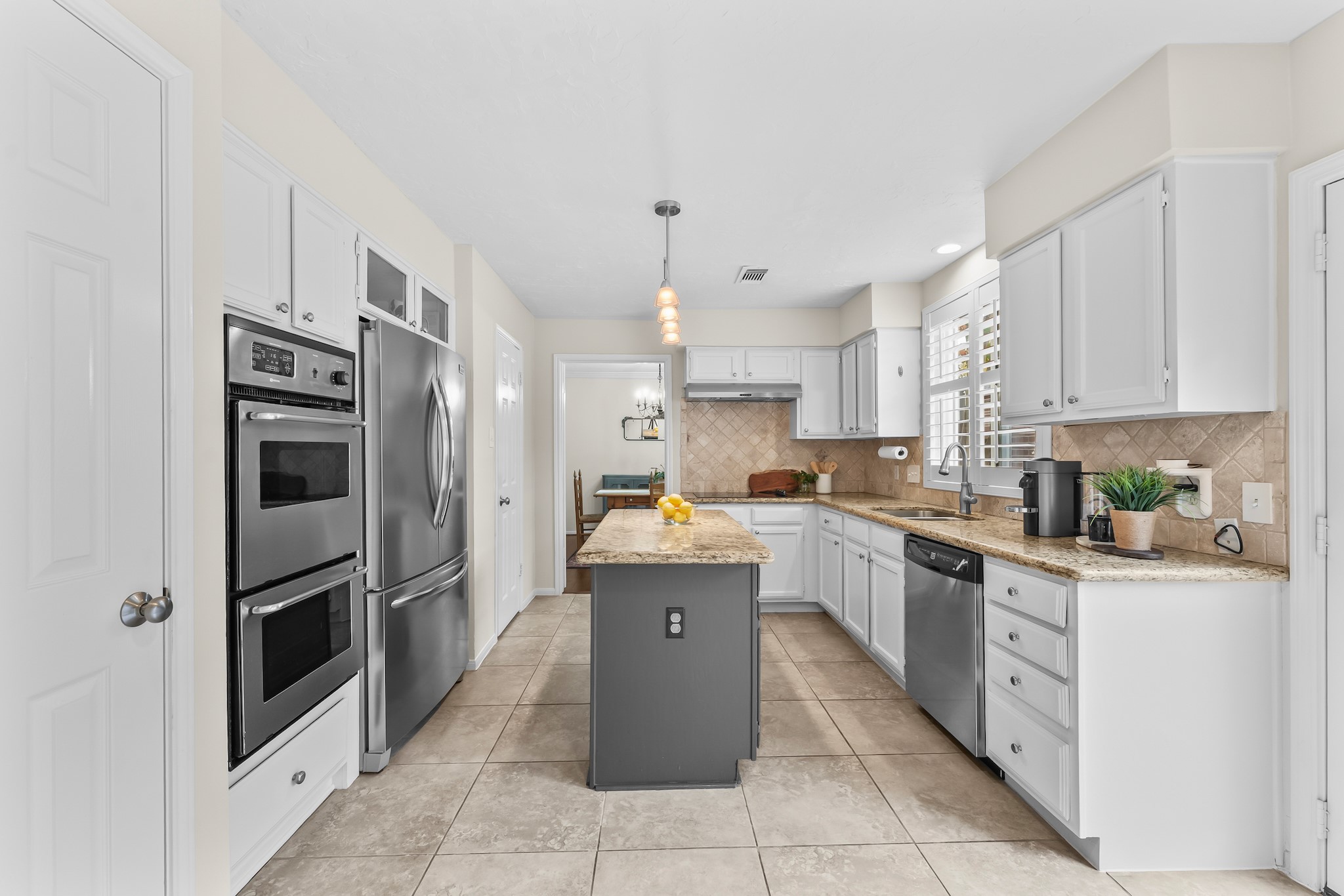 1546 Beaconshire Houston, TX 77077 - Photo 10 of 29 a kitchen with granite countertop a refrigerator and a stove top oven