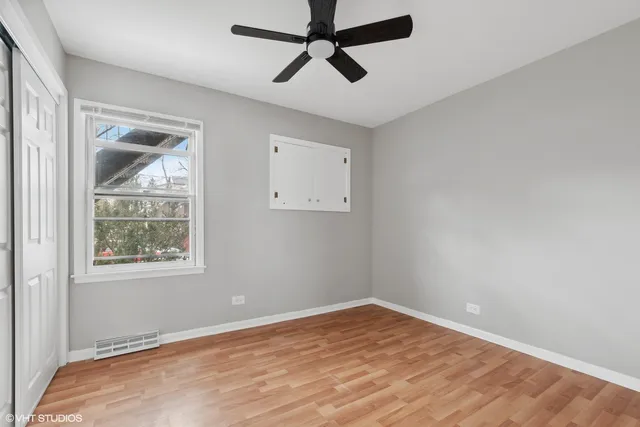 a view of empty room with wooden floor