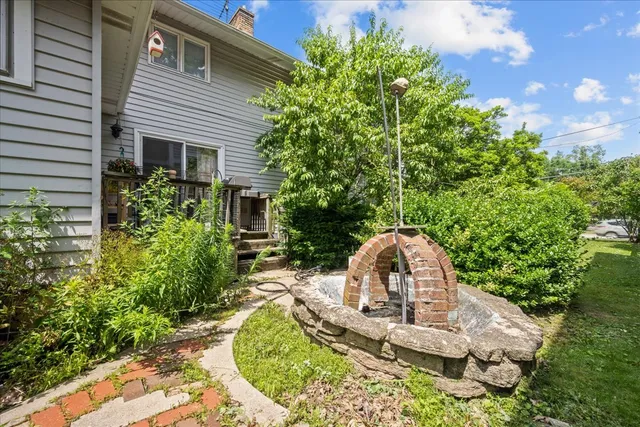 a kitchen with granite countertop stainless steel appliances a refrigerator cabinets and wooden floor