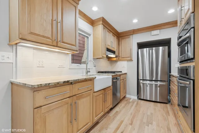 a view of a kitchen with a sink and a refrigerator