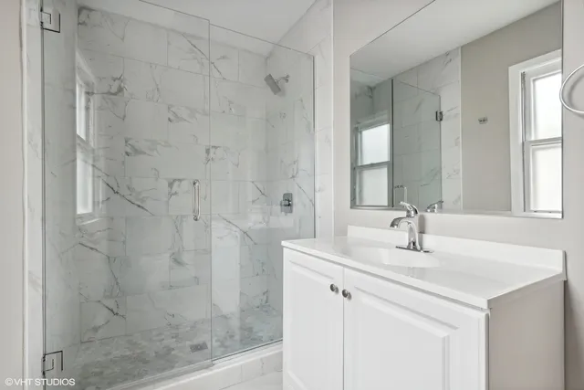 a view of a big room with wooden floor and a ceiling fan