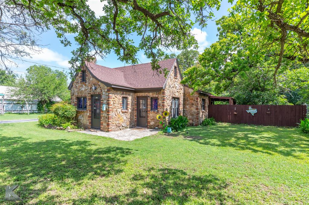 202 East Ross Street Rising Star, TX 76471 - Photo 5 of 40 a front view of a house with a yard and trees
