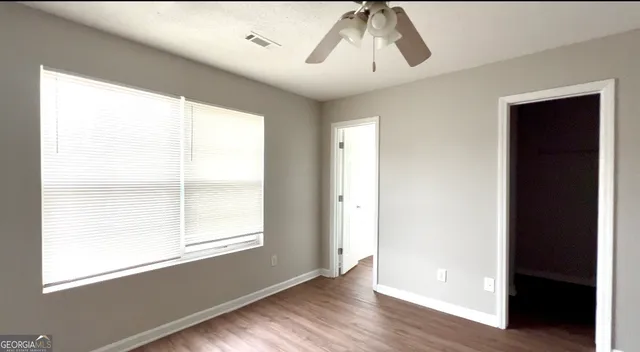 wooden floor in an empty room with a window