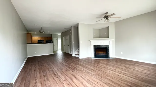 a view of an empty room with a fireplace and a window