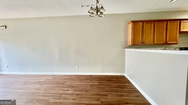 a view of room with window and wooden floor