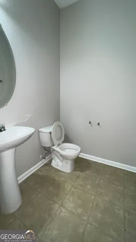 a white toilet sitting next to a bathroom sink