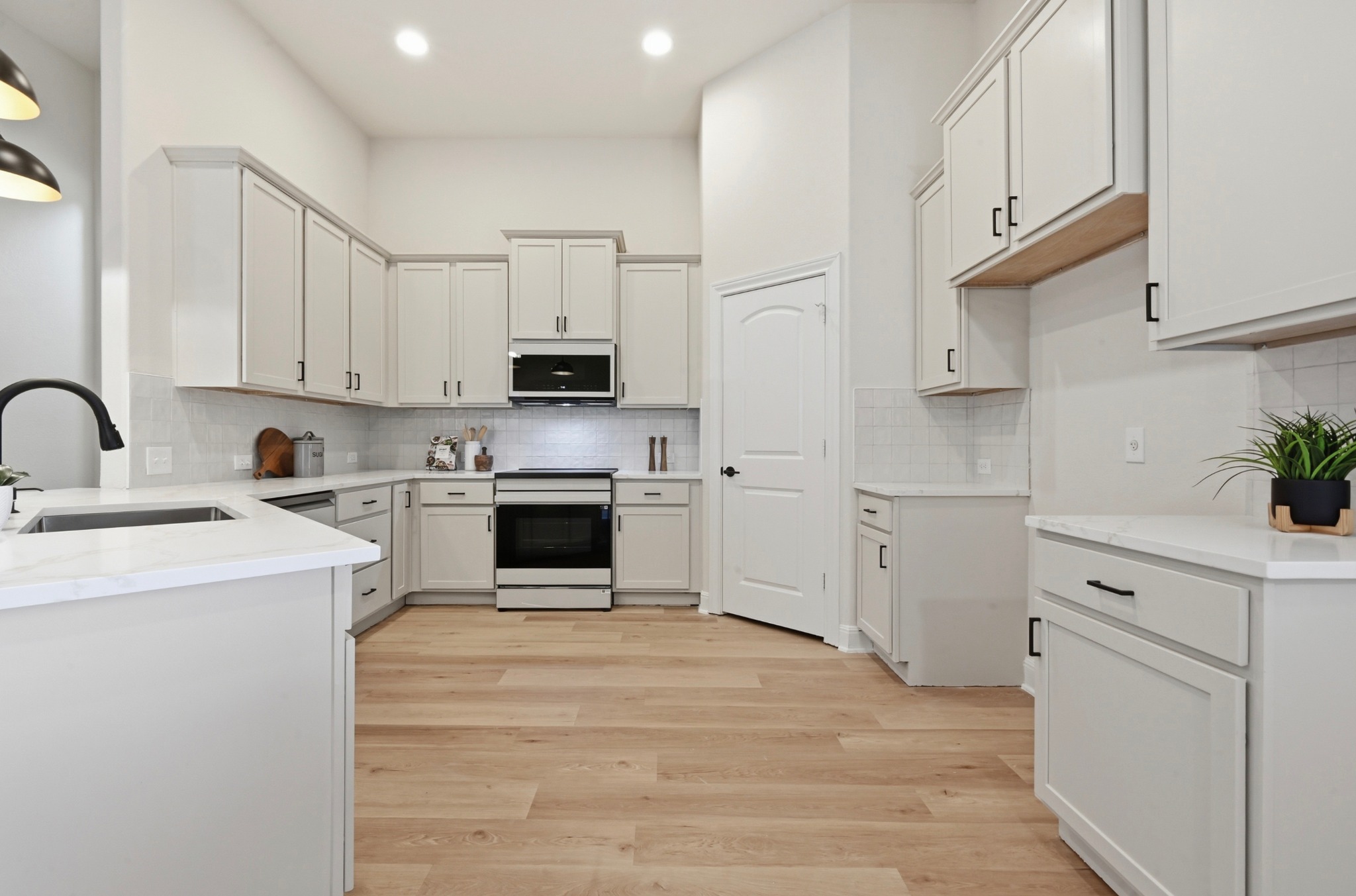 13009 Olivers Way Manchaca, TX 78652 - Photo 15 of 37 a kitchen with white cabinets and appliances