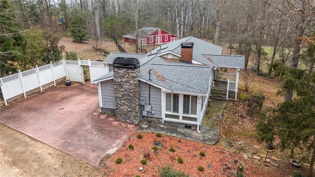 3819 Mason Creek Road Winston, GA 30187 - Photo 29 of 54 a view of a house with a small deck and backyard