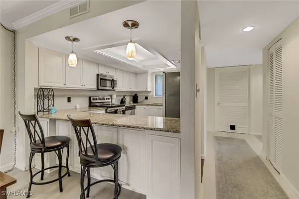 a kitchen with stainless steel appliances granite countertop a sink and cabinets